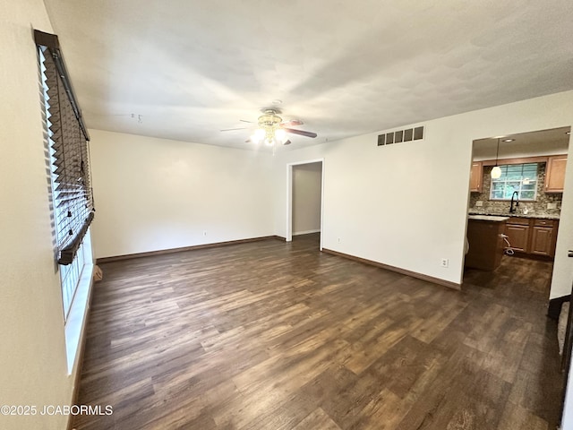 2412 Scenic Dr, Jefferson City, MO 65101 - unfurnished living room featuring ceiling fan and dark wood-style floors