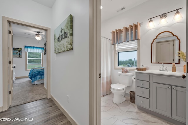 1308 Haxby Ct, Columbia, MO 65201 - ensuite bathroom with vanity, plenty of natural light, ceiling fan, and toilet