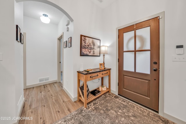 1308 Haxby Ct, Columbia, MO 65201 - foyer featuring arched walkways, light wood-type flooring, and baseboards