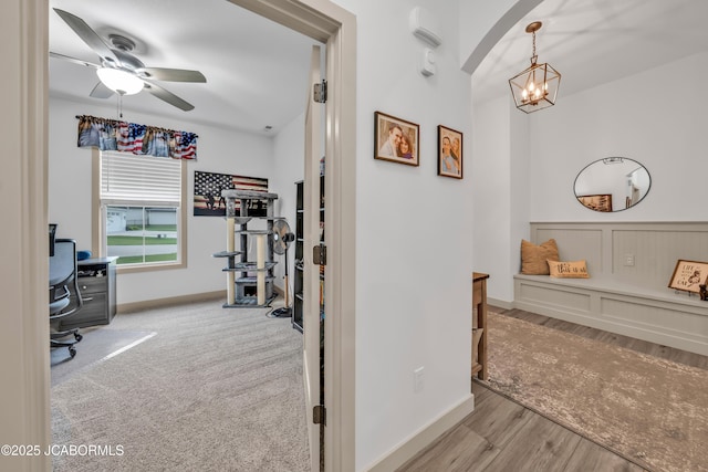 1308 Haxby Ct, Columbia, MO 65201 - hall featuring an office area, a chandelier, arched walkways, wood finished floors, and baseboards