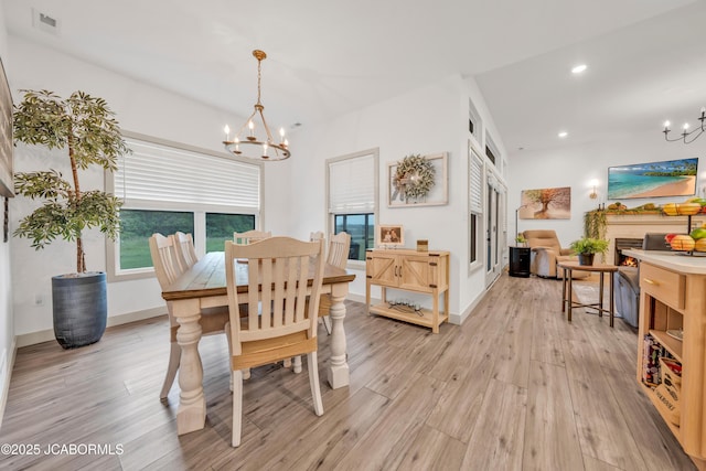1308 Haxby Ct, Columbia, MO 65201 - dining room with a chandelier, light wood-type flooring, recessed lighting, a lit fireplace, and baseboards