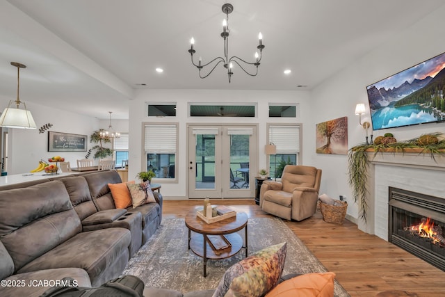 1308 Haxby Ct, Columbia, MO 65201 - living room with a chandelier, wood finished floors, a glass covered fireplace, and recessed lighting