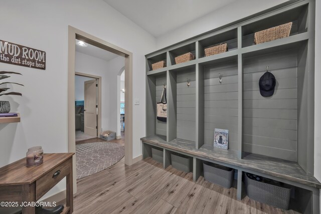 1308 Haxby Ct, Columbia, MO 65201 - mudroom featuring wood finished floors, arched walkways, and baseboards