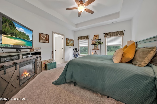 1308 Haxby Ct, Columbia, MO 65201 - carpeted bedroom with a tray ceiling and a ceiling fan