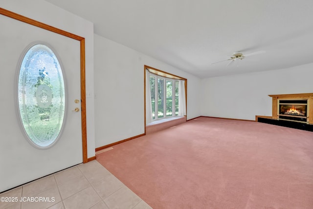 29311 State Highway Pp, California, MO 65018 - foyer with ceiling fan, light colored carpet, a glass covered fireplace, baseboards, and light tile patterned floors