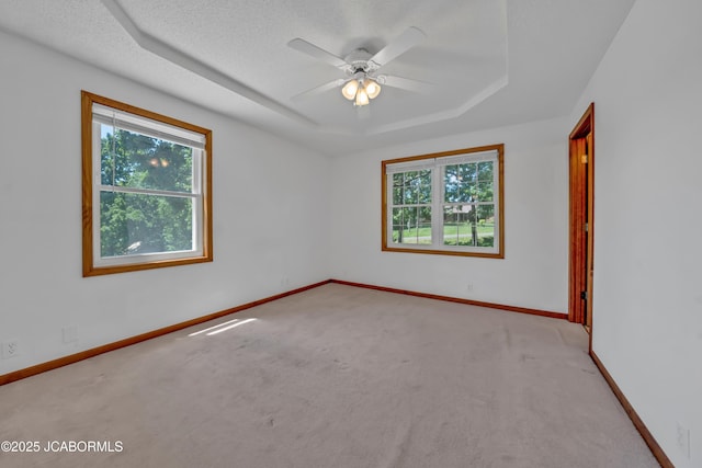 29311 State Highway Pp, California, MO 65018 - empty room featuring a tray ceiling, light carpet, a ceiling fan, and baseboards