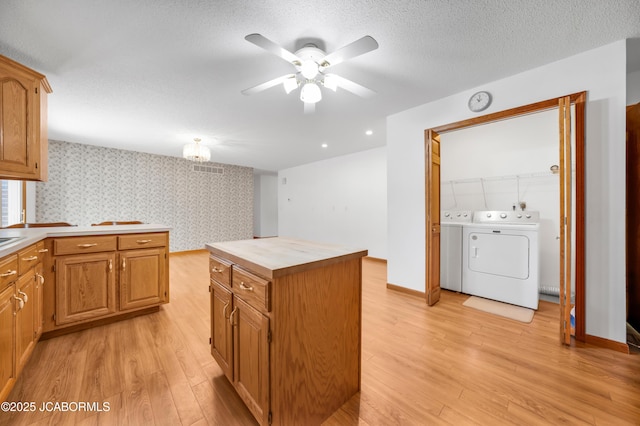 29311 State Highway Pp, California, MO 65018 - kitchen with independent washer and dryer, light wood finished floors, ceiling fan, wallpapered walls, and wood counters