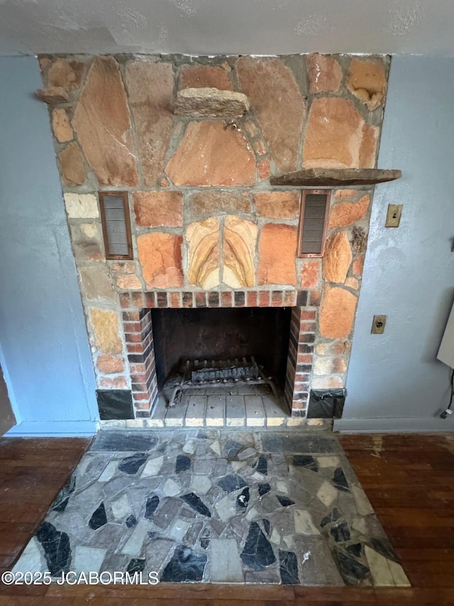5566 Bonnie Spring Valley Dr, Stover, MO 65078 - room details with baseboards, wood finished floors, and a large fireplace