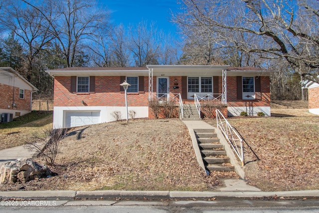 ranch-style home with a garage, stairs, cooling unit, a porch, and brick siding