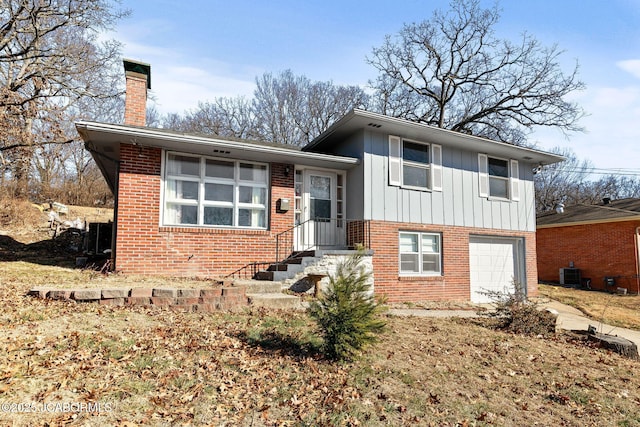 view of front of house featuring a garage and central air condition unit