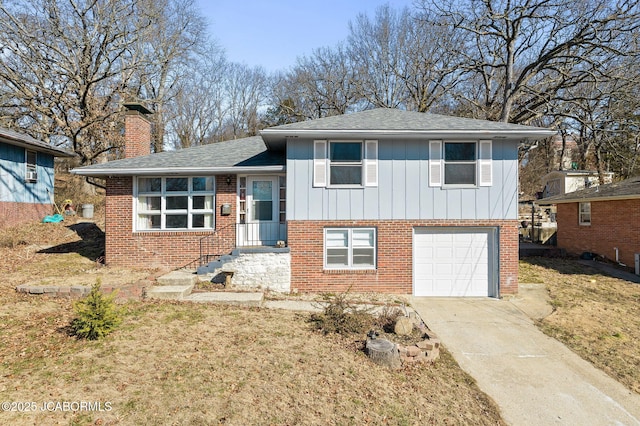 split level home featuring a garage and a front lawn