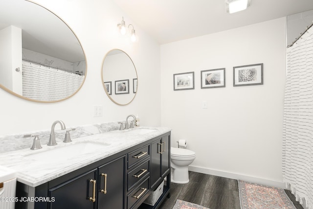 7165 E Hartman Rd, Hartsburg, MO 65039 - bathroom featuring wood finished floors and double vanity