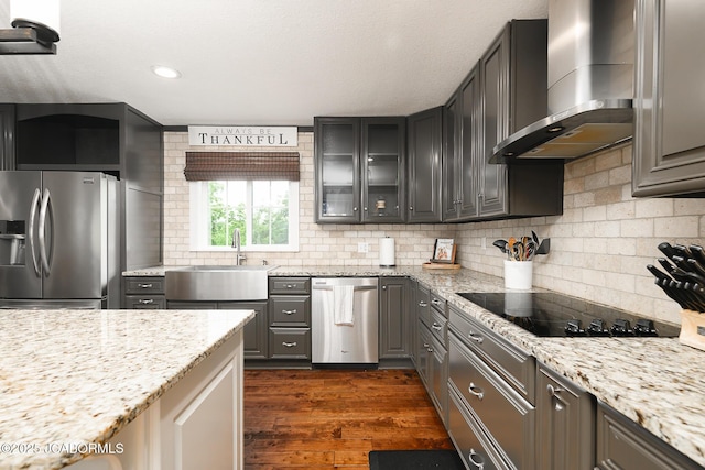 7165 E Hartman Rd, Hartsburg, MO 65039 - kitchen with appliances with stainless steel finishes, wall chimney exhaust hood, glass insert cabinets, dark wood finished floors, and backsplash