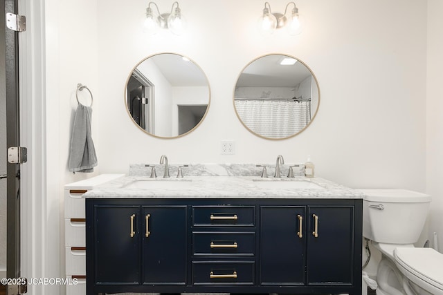 7165 E Hartman Rd, Hartsburg, MO 65039 - bathroom featuring double vanity and toilet