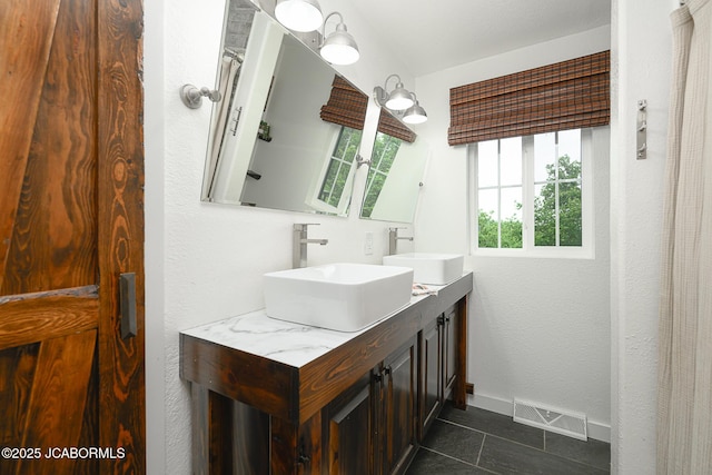 7165 E Hartman Rd, Hartsburg, MO 65039 - full bathroom with double vanity and tile patterned floors
