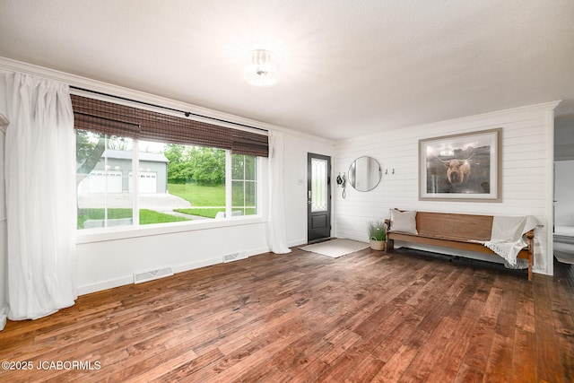 7165 E Hartman Rd, Hartsburg, MO 65039 - entryway featuring wood finished floors, crown molding, and wooden walls
