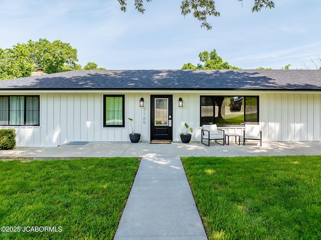 7165 E Hartman Rd, Hartsburg, MO 65039 - single story home featuring a front lawn, board and batten siding, and a shingled roof