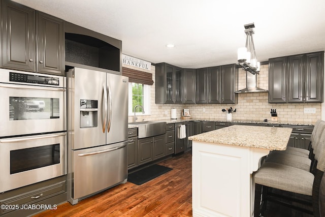 7165 E Hartman Rd, Hartsburg, MO 65039 - kitchen featuring stainless steel appliances, dark wood-style flooring, decorative backsplash, a kitchen island, and recessed lighting