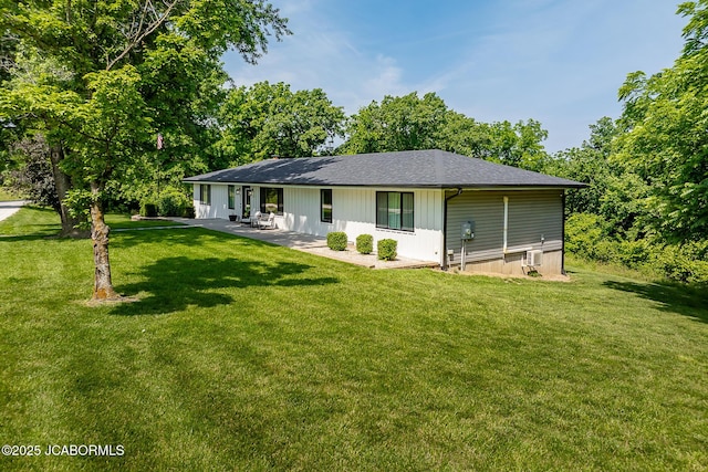 7165 E Hartman Rd, Hartsburg, MO 65039 - rear view of property featuring a lawn, a patio area, and a shingled roof