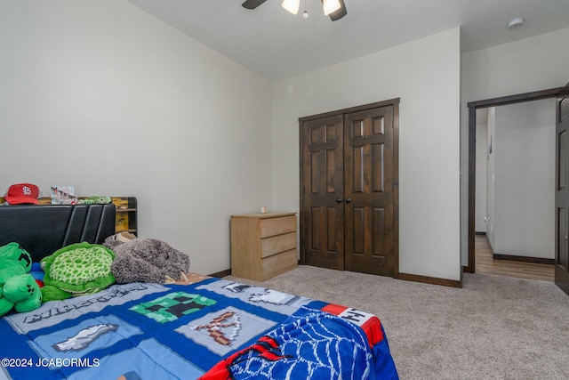 carpeted bedroom featuring a closet and ceiling fan