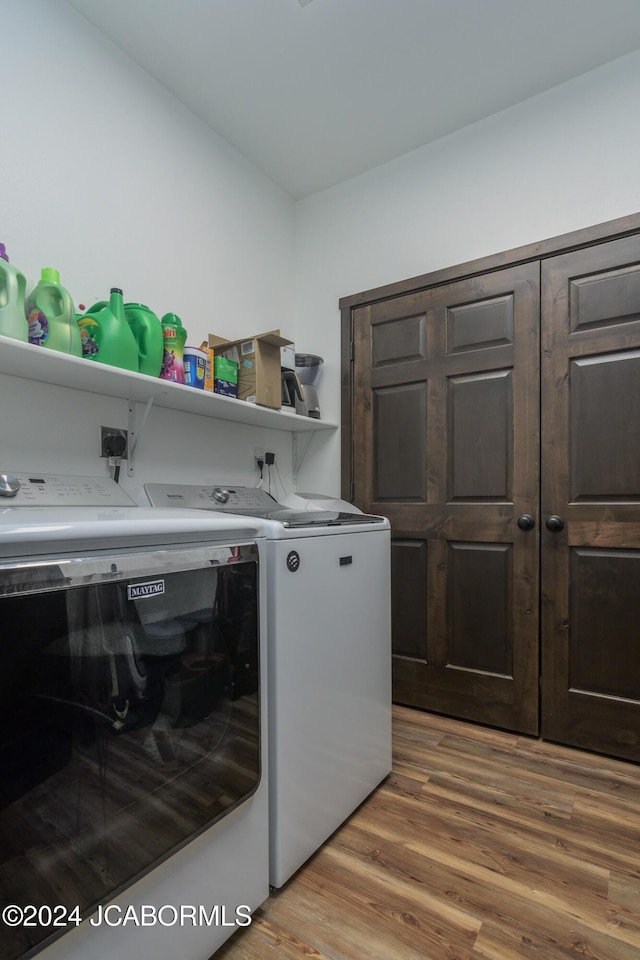 laundry room featuring washer and dryer and hardwood / wood-style flooring