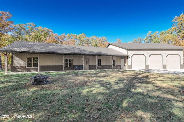 view of front of property with a front yard and a garage