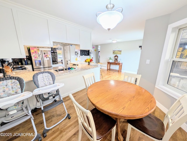 dining space with light wood-style flooring