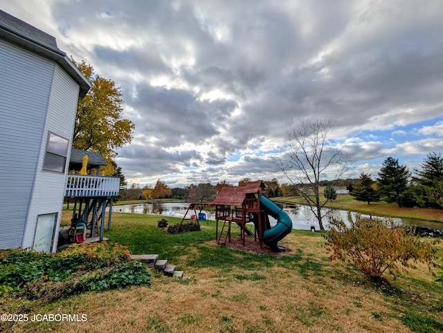 view of play area with a water view and a yard