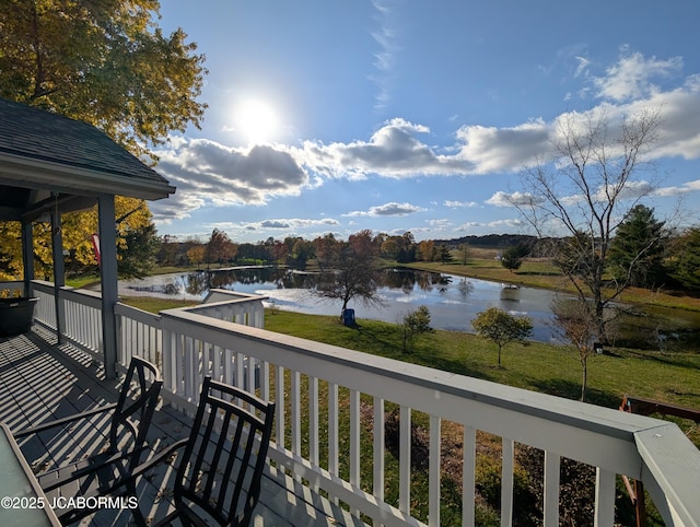 wooden terrace featuring a water view