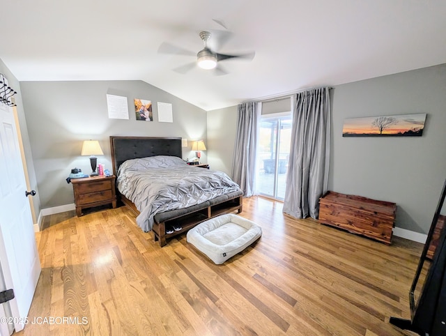 bedroom featuring access to exterior, vaulted ceiling, light wood-style flooring, and baseboards