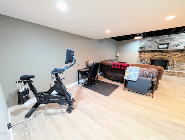 bedroom with a fireplace, baseboards, wood finished floors, and recessed lighting