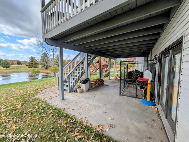 view of patio / terrace with a water view and stairway