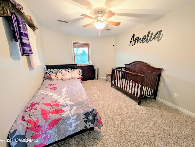 carpeted bedroom with ceiling fan, visible vents, and baseboards