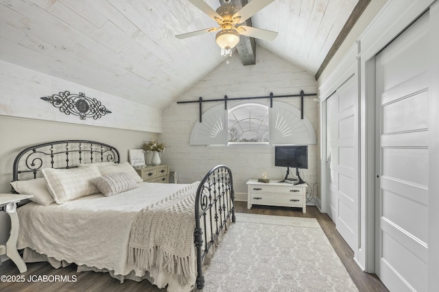 bedroom with wood-type flooring, lofted ceiling with beams, ceiling fan, and wood ceiling