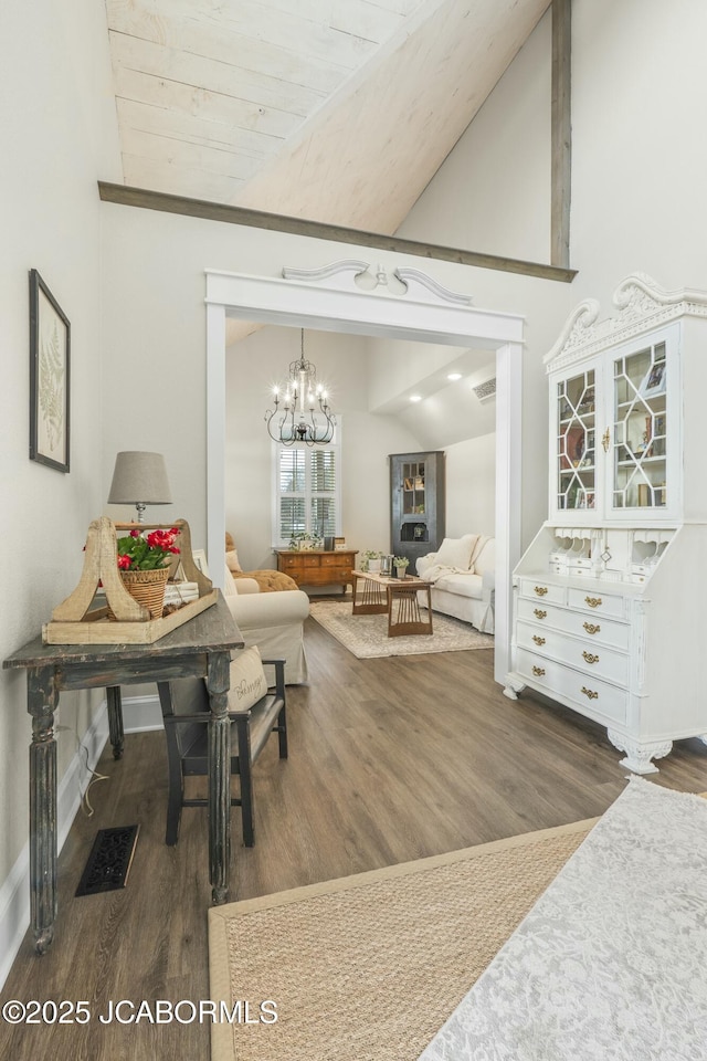 interior space featuring a notable chandelier, dark hardwood / wood-style floors, wooden ceiling, and vaulted ceiling