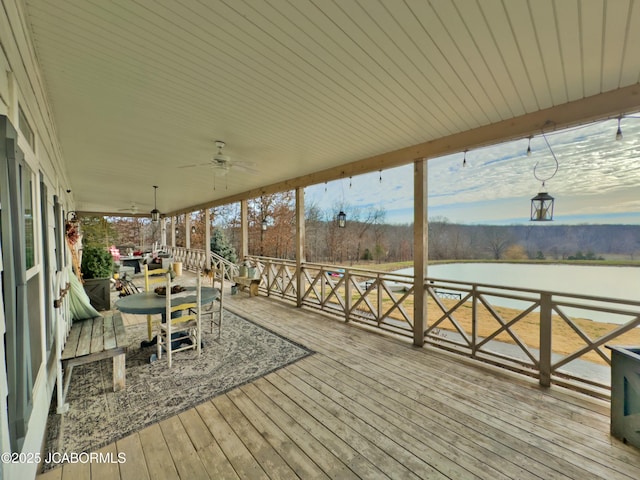 wooden terrace featuring a water view and ceiling fan