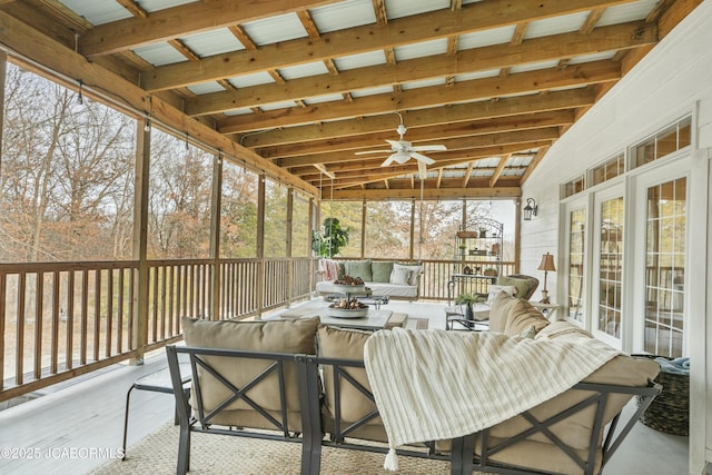 sunroom featuring ceiling fan and lofted ceiling