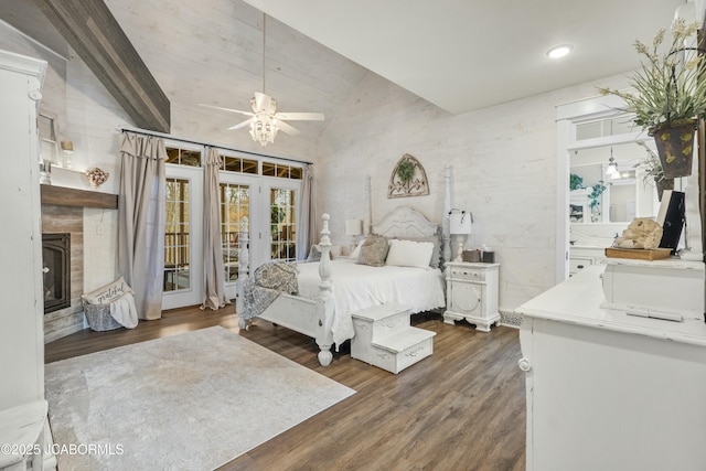 bedroom with ceiling fan, dark hardwood / wood-style floors, lofted ceiling, and access to outside