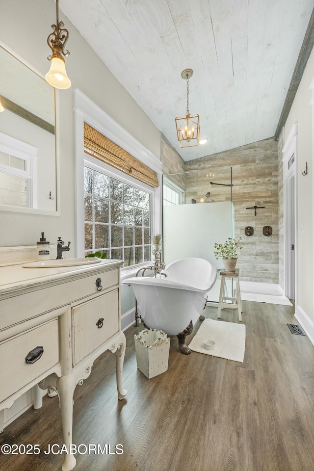 bathroom featuring sink, wooden ceiling, a chandelier, wood-type flooring, and wooden walls