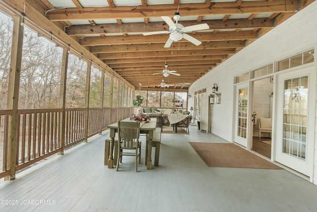 unfurnished sunroom featuring vaulted ceiling and ceiling fan