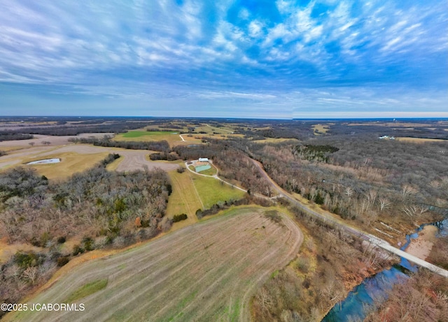 birds eye view of property with a water view and a rural view