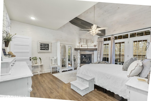 bedroom featuring access to exterior, hardwood / wood-style flooring, high vaulted ceiling, and ceiling fan