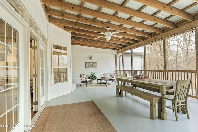 sunroom with vaulted ceiling with beams and ceiling fan