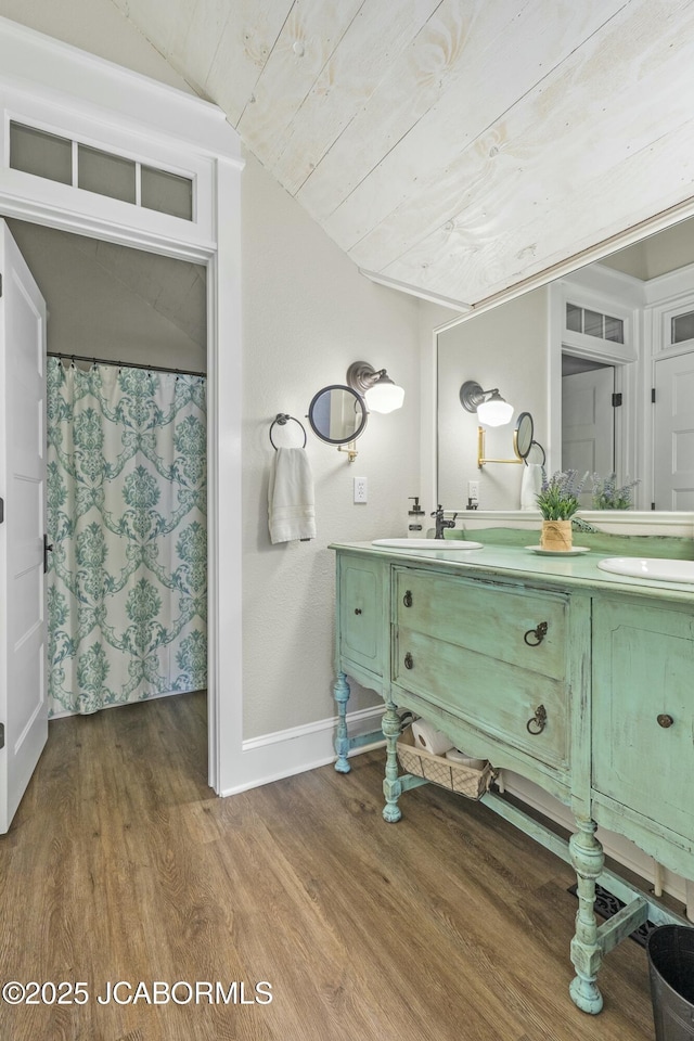 bathroom featuring hardwood / wood-style floors, vanity, lofted ceiling, and wood ceiling