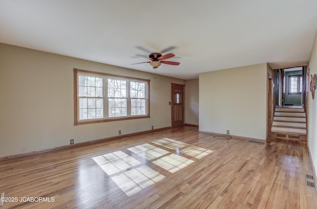 302 Park Rd, Fayette, MO 65248 - unfurnished living room featuring ceiling fan, light wood-style flooring, stairs, baseboards, and visible vents