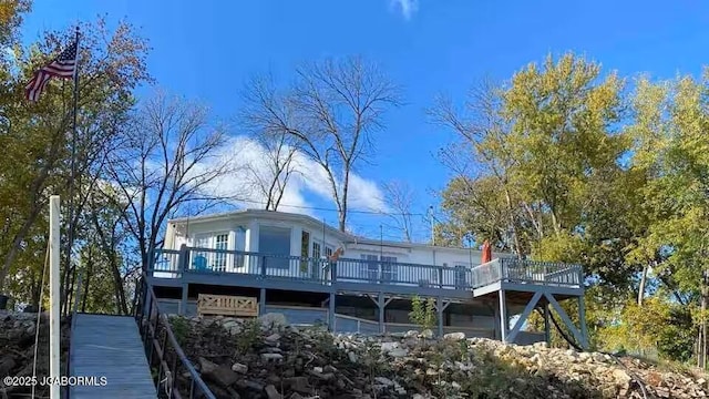 rear view of house featuring a deck and stairway