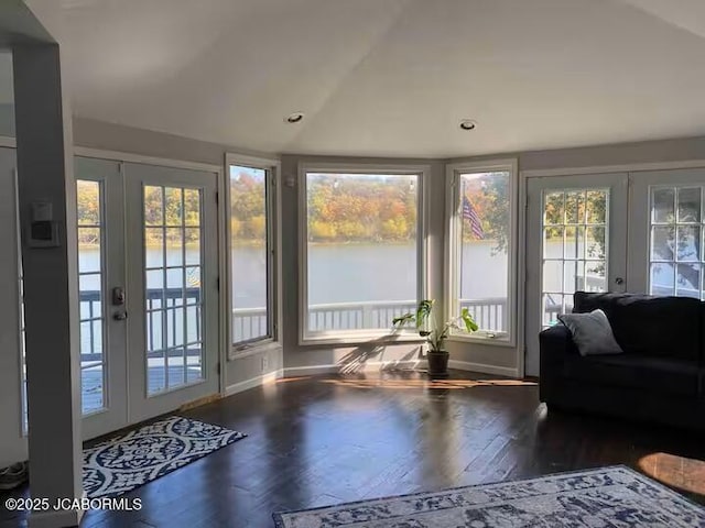 sunroom featuring lofted ceiling and french doors