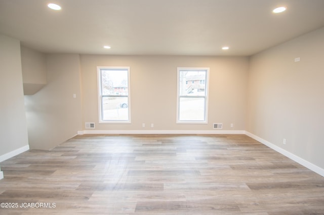 unfurnished room featuring plenty of natural light, visible vents, and recessed lighting