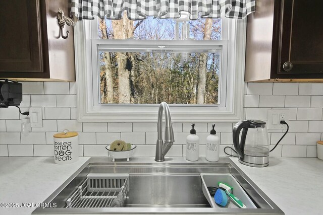 kitchen featuring decorative backsplash, dark brown cabinets, and appliances with stainless steel finishes