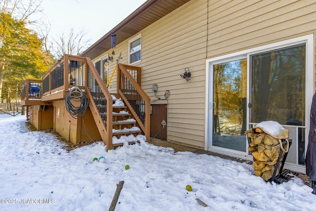 view of snow covered exterior with a deck